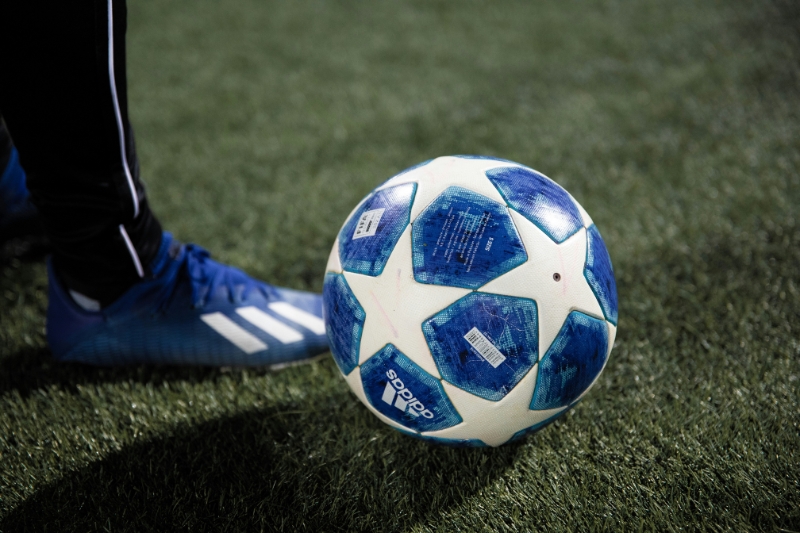 Player standing over a champions league ball