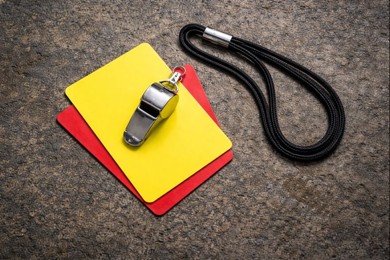 a premier league referees yellow and red cards and a whistle