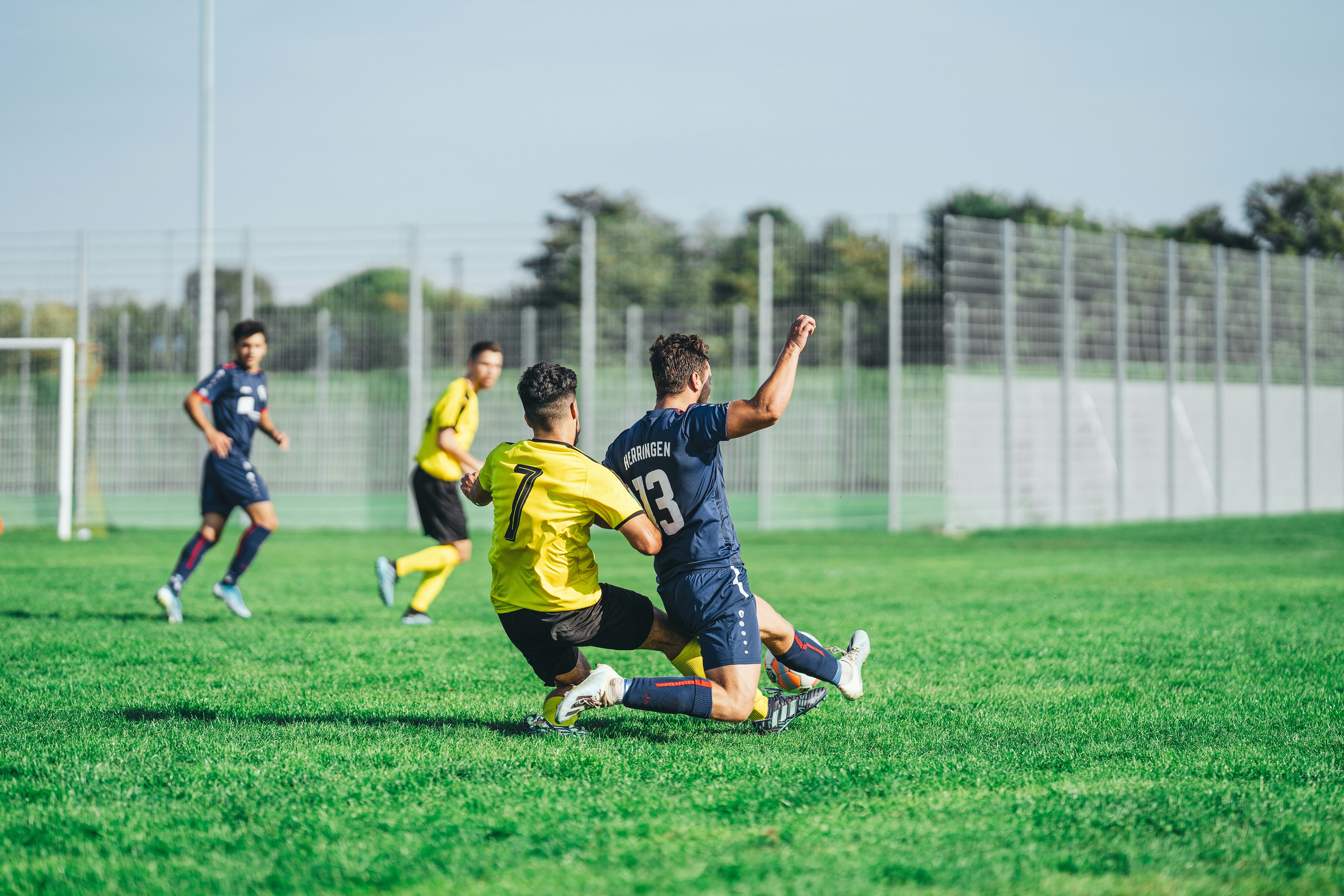 Football Player being tackled and fouled
